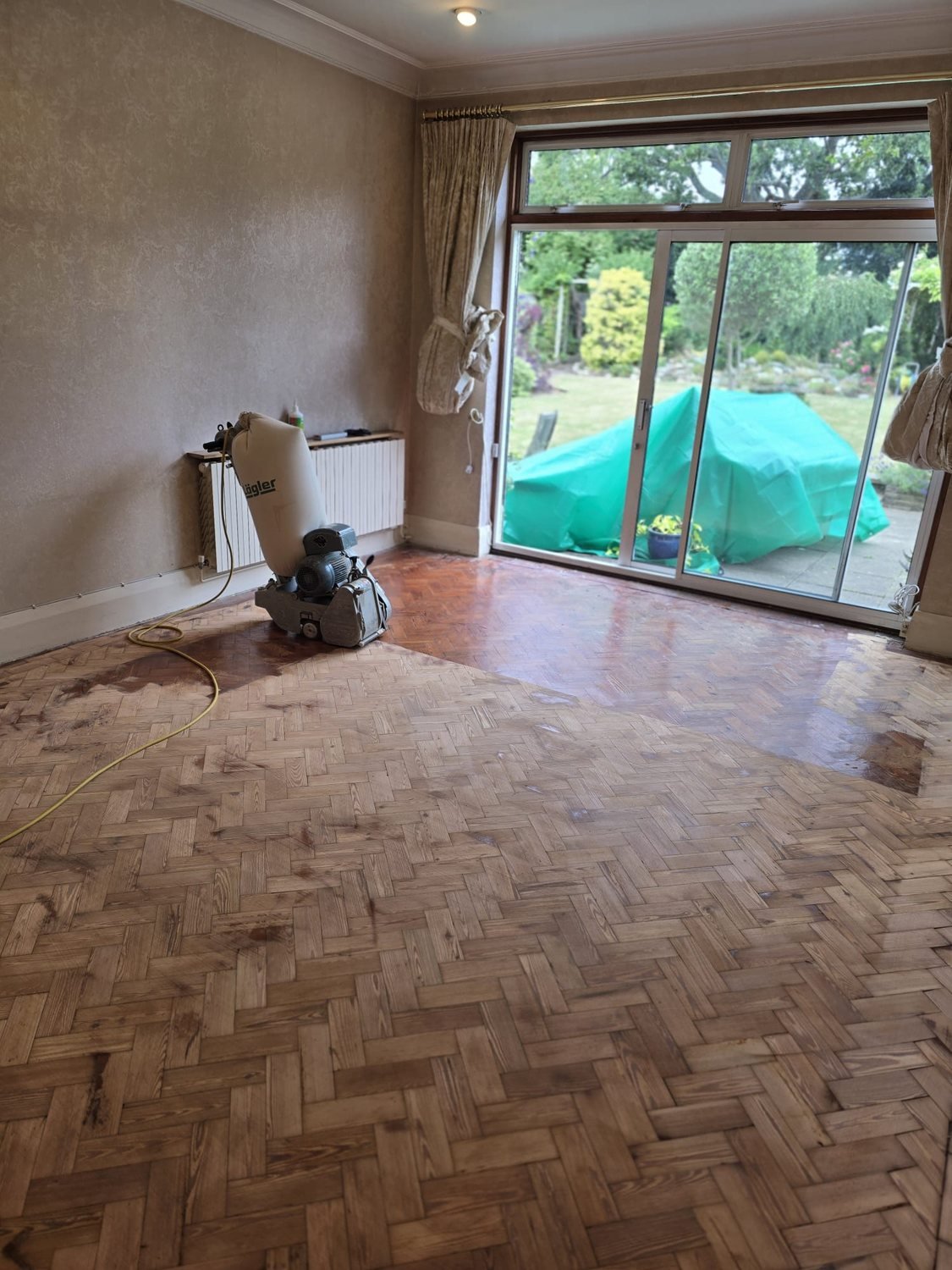 Pitch pine parquet floor mid-sanding in Brixton, London