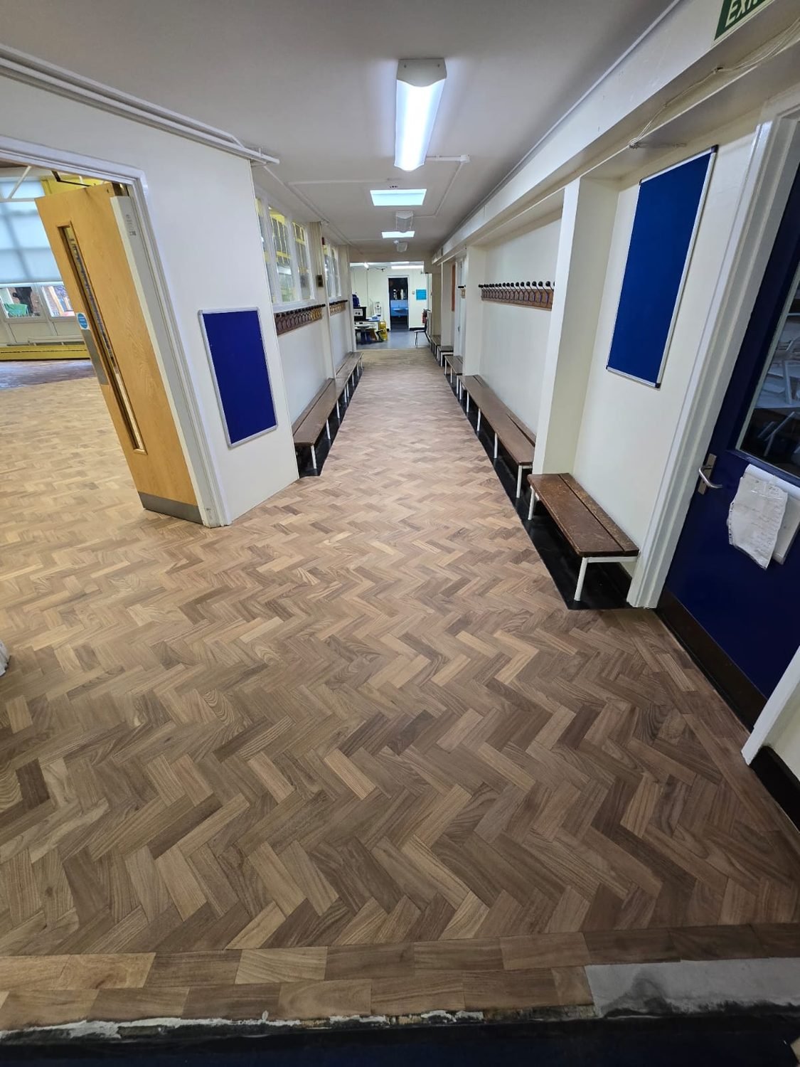 Restored parquet floor in a school corridor in Croydon