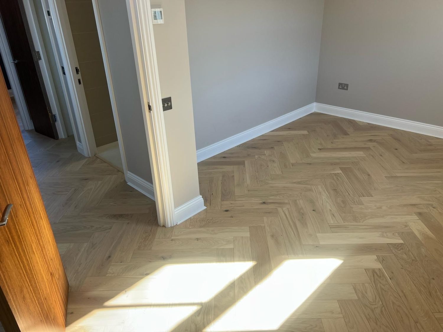 New herringbone wood floor in a room in Hackney, London