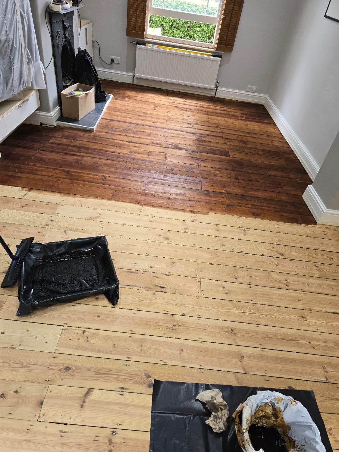 Pine floor part-stained during restoration in Wandsworth