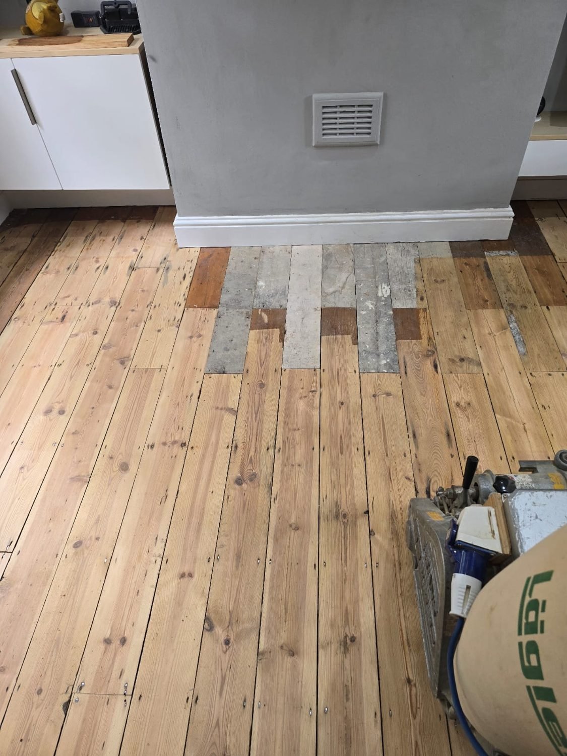 Repairing and replacing pine floorboards around the hearth in Wandsworth