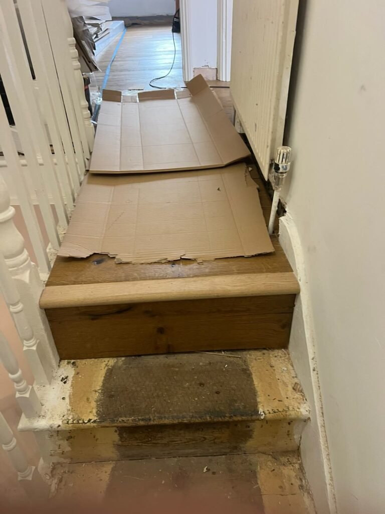 Stair tread repaired and clad with matching engineered flooring and stair nosing