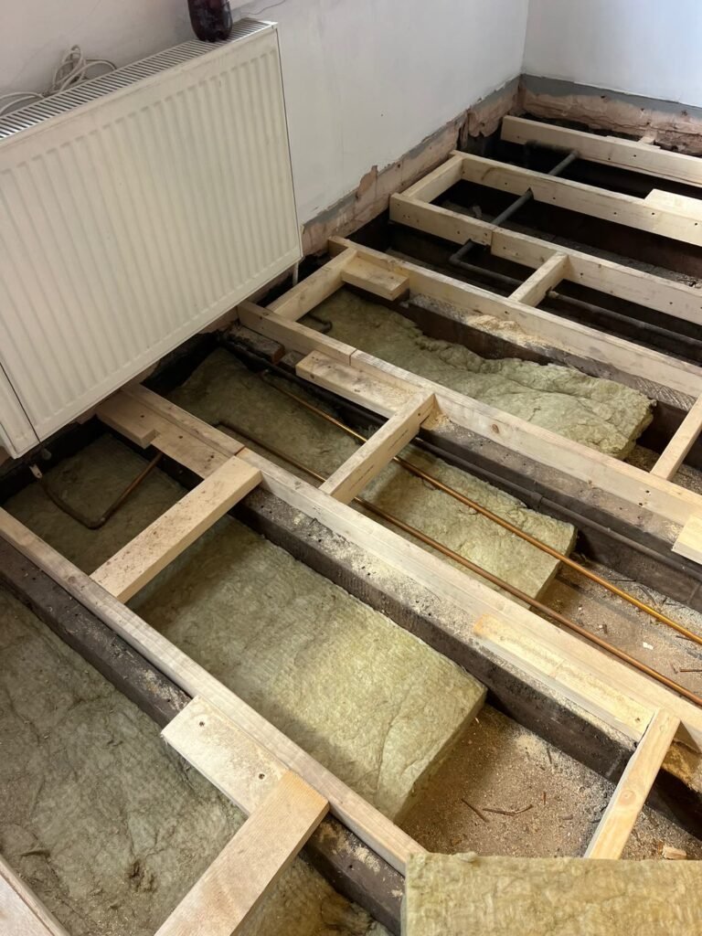 Mineral wool insulation fitted between the floor joists